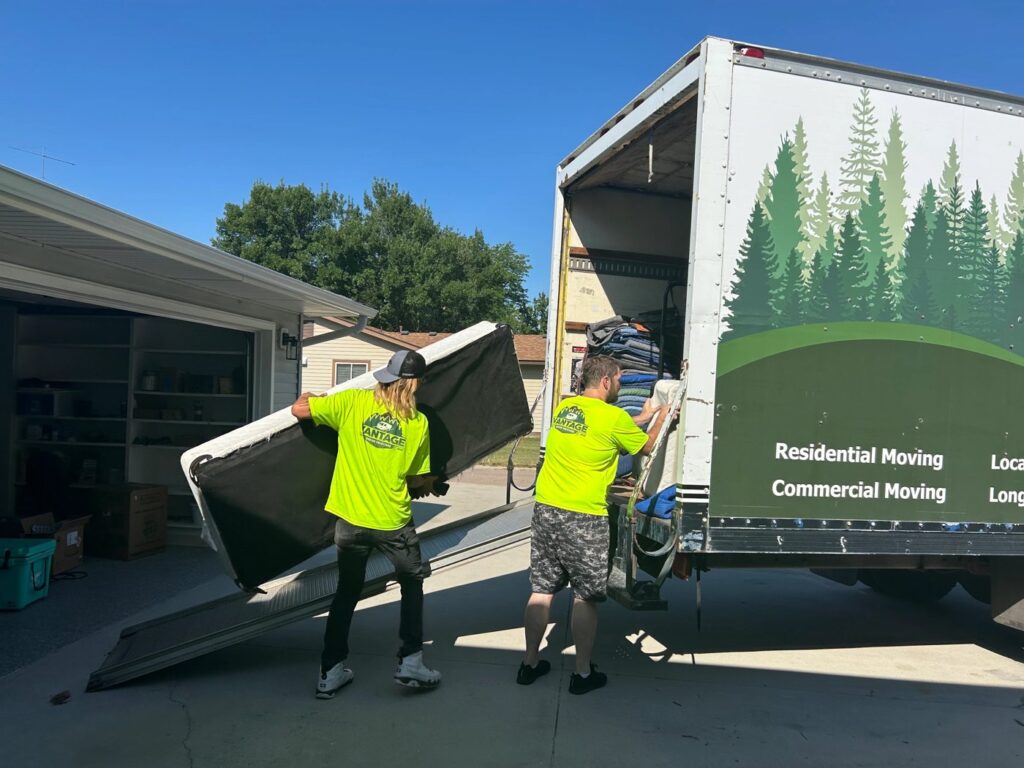 Vantage movers carrying a mattress to the truck